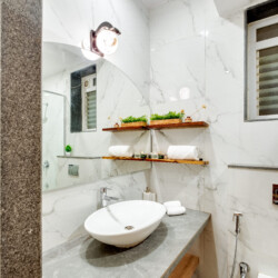 Ina - Villa in Siolim Goa - Washroom with washbasin, shaving mirror, towels, and libght