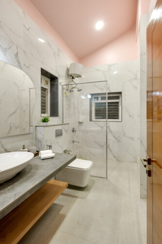 Ina - Villa in Siolim Goa - Washroom 4 with washbasin, shaving mirror, towels, and libght